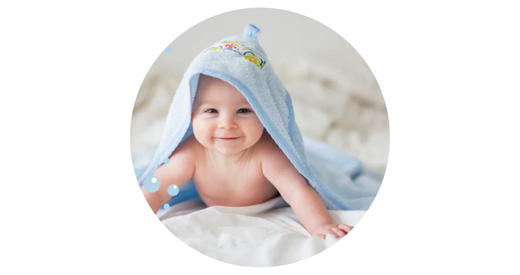 Happy baby under a blanket playing peek-a-boo